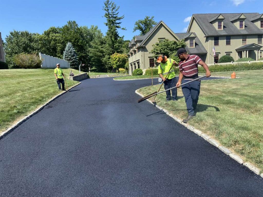 BC Paving crew raking fresh asphalt